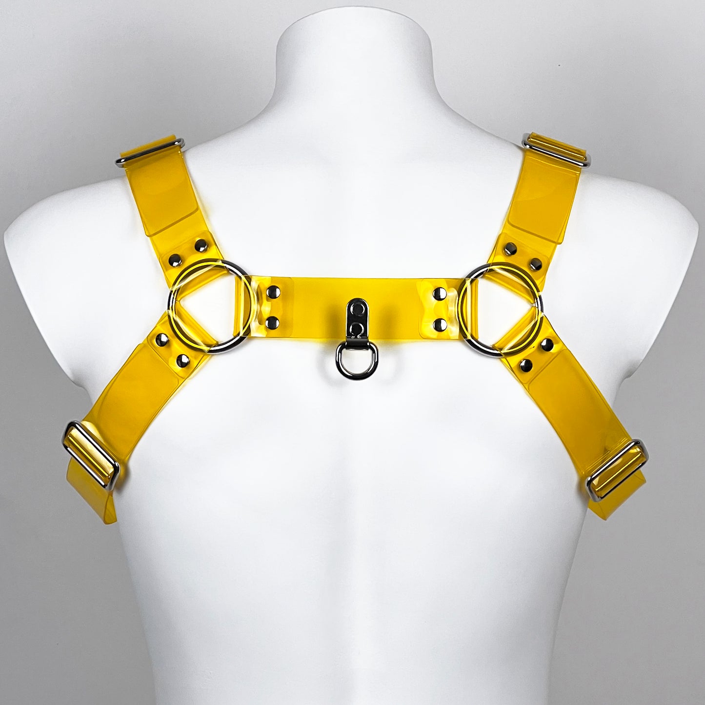 BDSM harness in yellow transparent PVC with metallic buckles