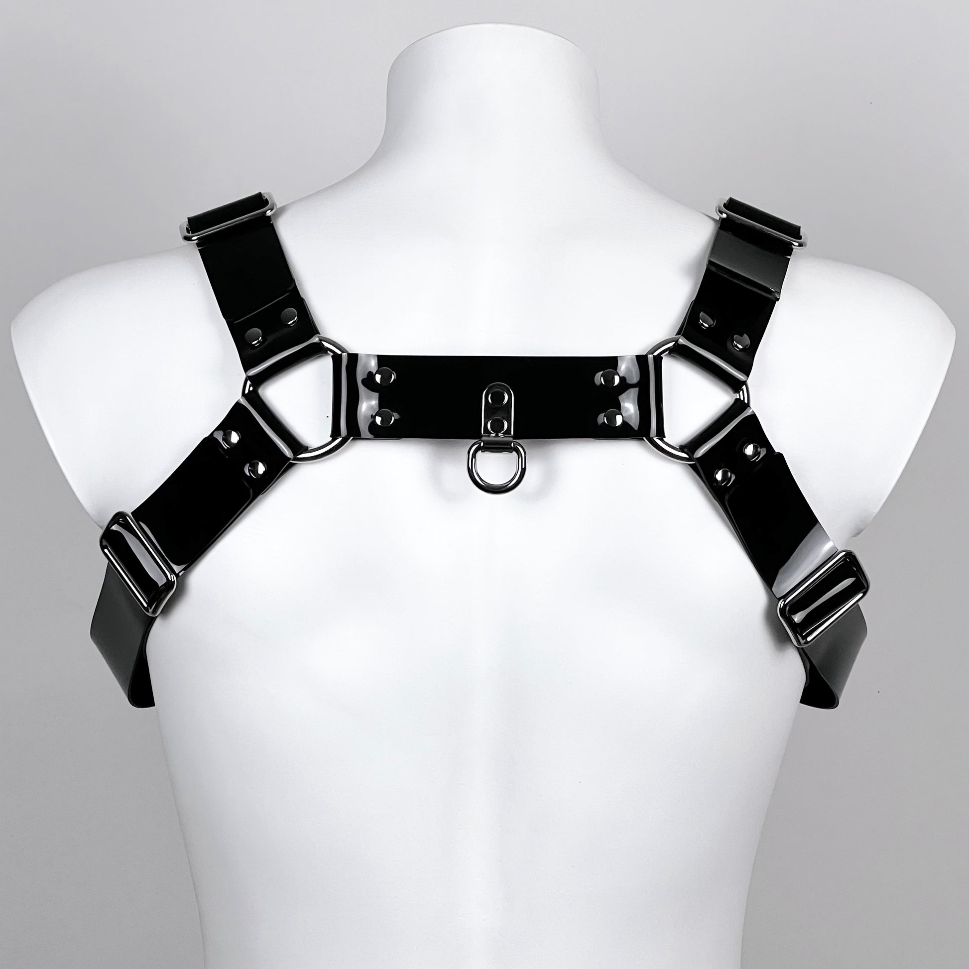 BDSM harness in black PVC with metallic buckles